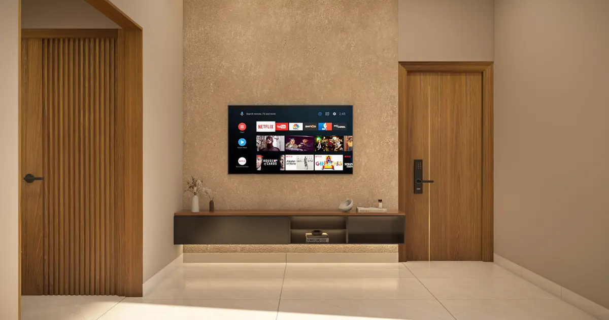 The living room seen towards a fluted timber media wall with a television mounted on it and a panelled door alongside.