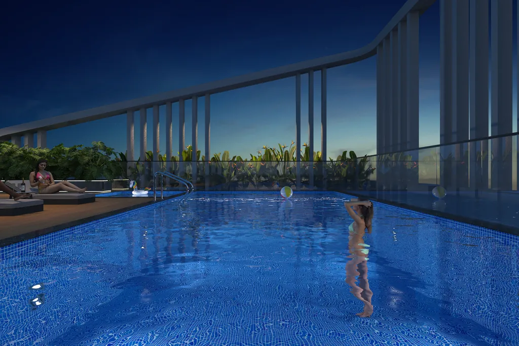 The swimming pool on the podium, tiled in blue, with loungers along one side and planting behind.